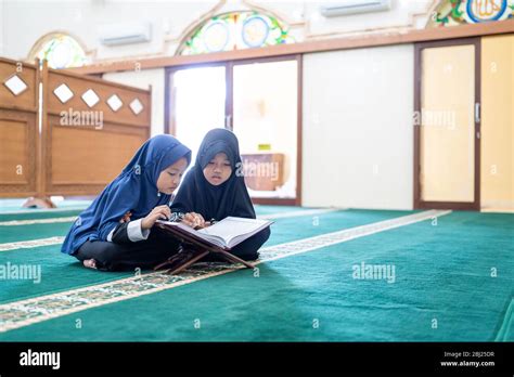 Two Kids Read Holy Quran Together In The Mosque Stock Photo Alamy