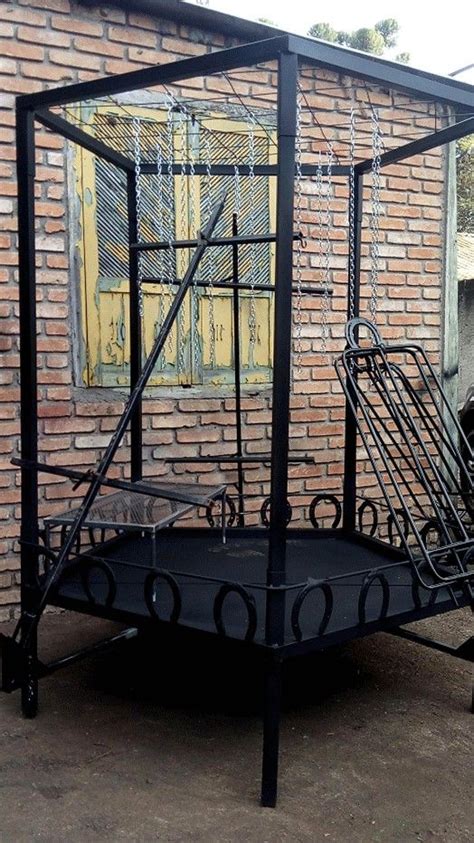 A Metal Bed Frame Sitting In Front Of A Brick Building