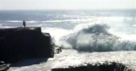 Watch Woman Swept Away By Huge Wave