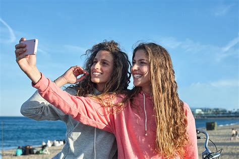 Two Young Woman Taking A Selfie By The Beach By Stocksy Contributor