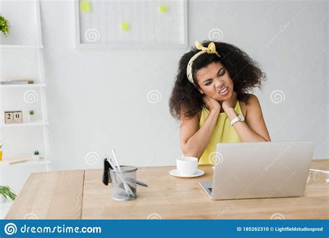 Curly Brunette African American Woman Having Neck Pain Stock Photo