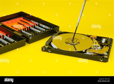 Hard Disk Repair On A Yellow Background With A Set Of Screwdrivers Q