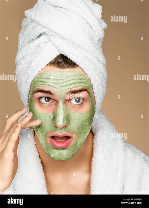 Portrait Of Man Applying Avocado Facial Mask To Face Photo Of Well