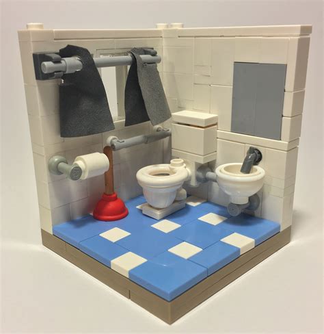 A Lego Model Of A Bathroom With Two Toilets And A Toilet Paper Dispenser