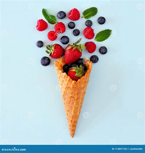 Mixed Berries In Ice Cream Cone Flat Lay Over A Blue Background Stock