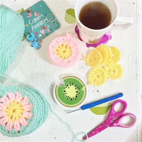 Crocheted Items Are Laid Out On A Table Next To A Cup Of Coffee