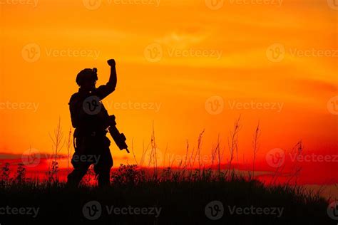 Silhouette of military soldier or officer with weapons at sunset ...