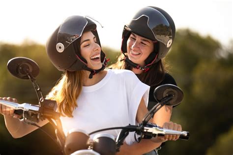 Free Photo Lesbian Couple On A Motorcycle With Helmets On