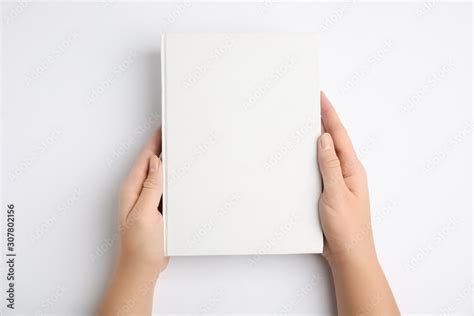 Woman holding book with blank cover on white background, top view Stock Photo | Adobe Stock