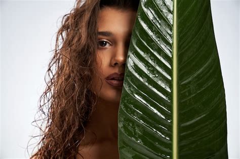 Premium Photo Naked Woman Hiding Face Behind Big Green Leaf