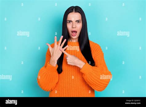 Photo Of Impressed Shocked Woman Wear Orange Sweater Pointing Finger