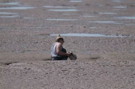 Woman has to be rescued after getting stuck in the mud at popular beach - Worldnews.com