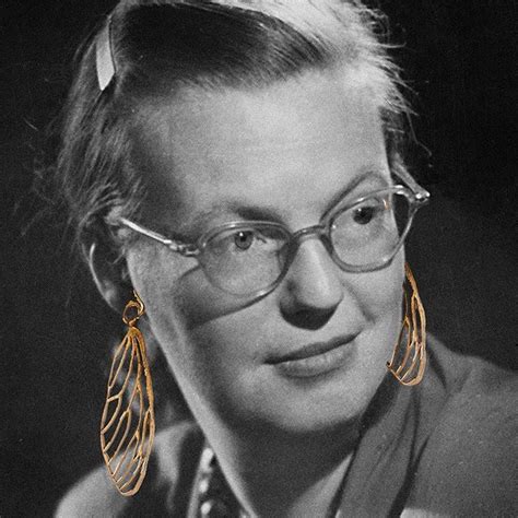 A Black And White Photo Of A Woman Wearing Glasses With Large Gold