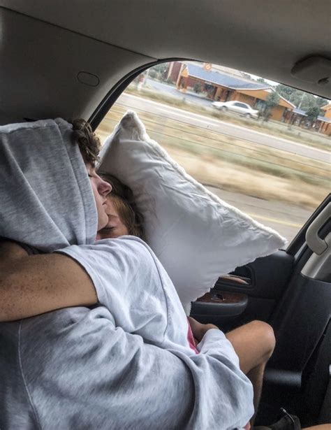 A Man Sleeping In The Back Seat Of A Car With His Head On A Pillow