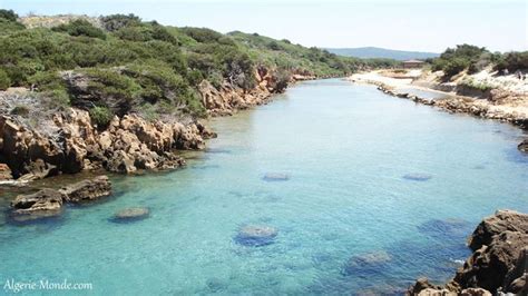 The Water Is Crystal Blue And Clear With Rocks On Both Sides And Green