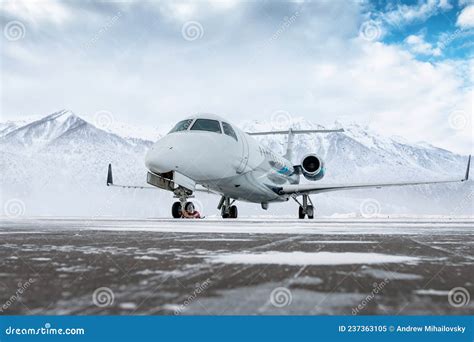 Corporate Business Jet On The Winter Airport Apron On The Background Of