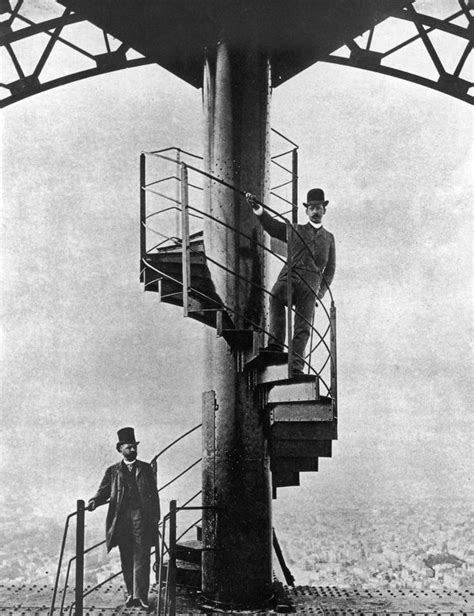 Two Men Are Standing On The Top Of A Tall Tower While Another Man