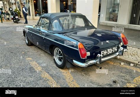 Dark Blue 1970 S Mg Mgb Roadster Parked By The Curbside Back Left