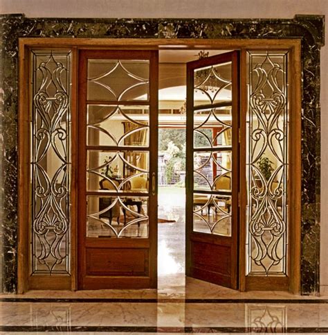 An Open Door Leading Into A Room With Marble Flooring And Glass Panels