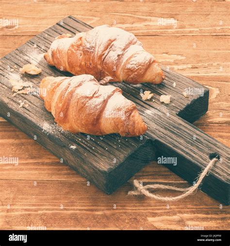 Croissants On Rustic Cutting Board Stock Photo Alamy