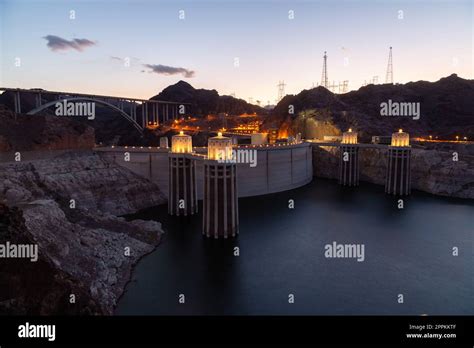 Hoover Dam at sunset in the evening with illuminations without people ...