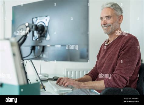 Mature Man Working On Computer At Home Stock Photo Alamy
