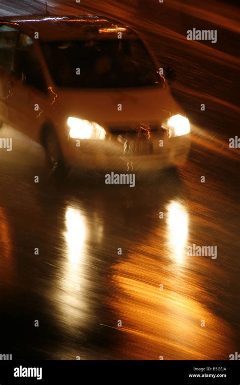 fast car driving in heavy rain at night in town Stock Photo - Alamy