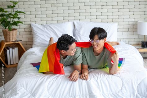 Happy Asian Gay Couple Talking Together And Relaxing At Home On Bed LGBTQ Concept Stock Photo