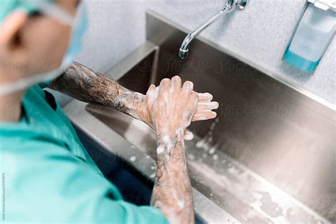 Surgeons Washing Hands Before Operating By Stocksy Contributor Santi