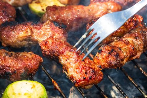 Grilling Meat Rolls Called Mici Or Mititei With Vegetables On Char