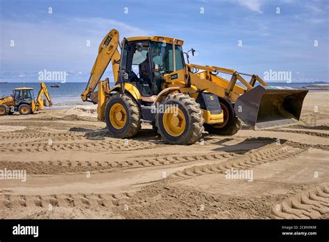 Backhoe Beach Digger Working On The Beach Reclamation Project At