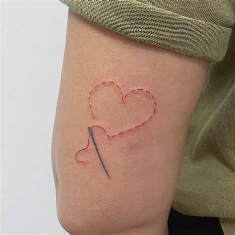 Hand Poked Thread And Needle Tattoo Located On The