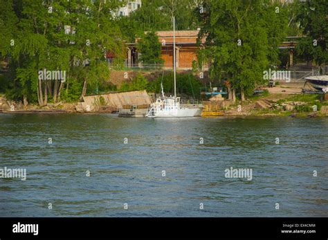 white boat is near the shore Stock Photo - Alamy