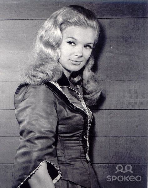 An Old Black And White Photo Of A Woman In A Dress With Long Blonde Hair