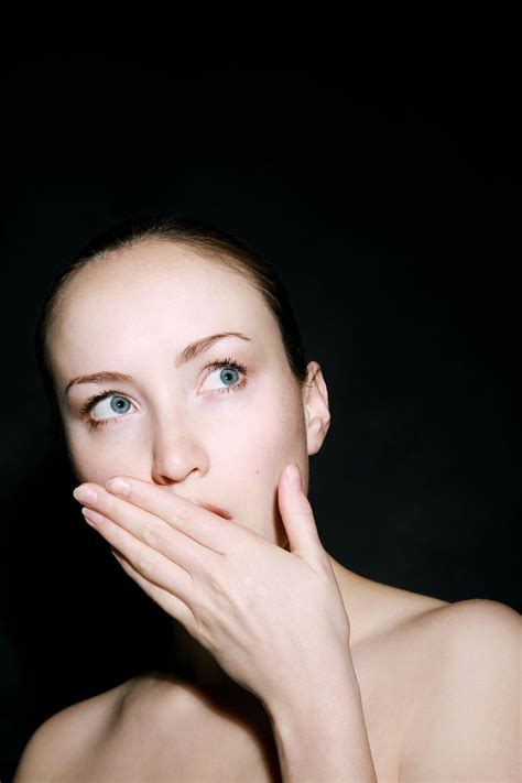 A Woman With Her Hands On Her Face