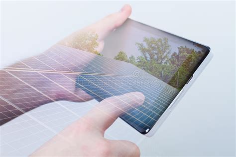 Double Exposure Hand Holding Digital Tablet Solar Panels On Sc Stock