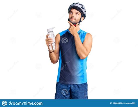 Handsome Hispanic Man Wearing Bike Helmet And Holding Water Bottle