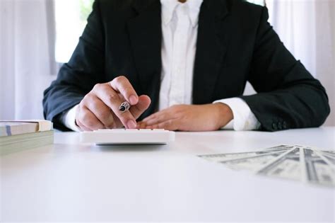 Premium Photo Midsection Of Businessman Using Calculator On Table