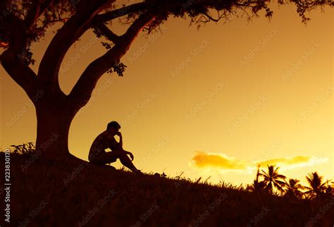 Sad lonely man sitting in the park. Stock Photo | Adobe Stock