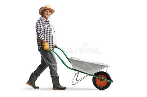 Full Length Profile Shot Of A Mature Male Gardener Pushing A