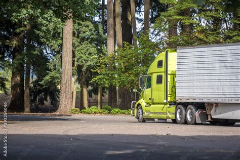 Bright green big rig industrial semi truck with refrigerator semi ...