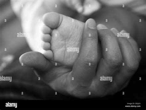 Parents Hands Hold Baby Boy Legs Stock Photo Alamy