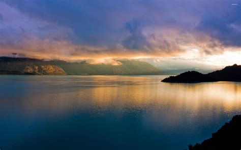 Foggy mountains by the calm water at sunset wallpaper - Nature ...