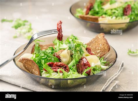 Salad With Frisee Lettuce Sun Dried Tomatoes Cheese And Bread Chips