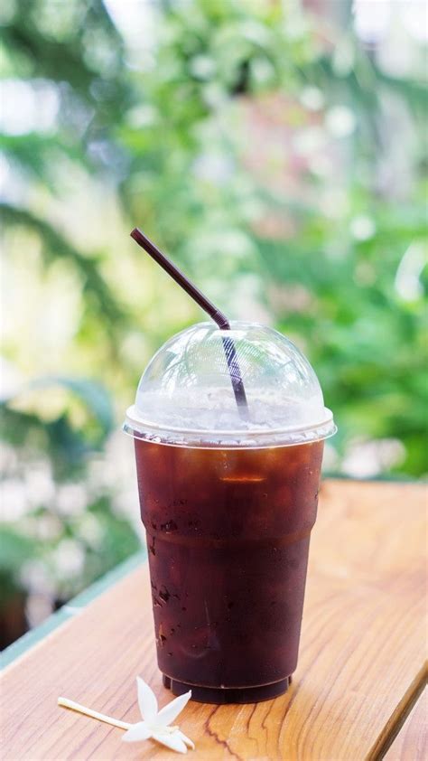 Premium Photo Iced Black Coffee On The Wooden Table Iced Black