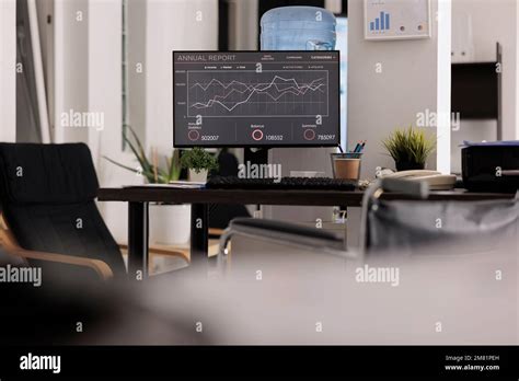 Desk With Annual Report Graphics On Computer Screen Office Wheelchair