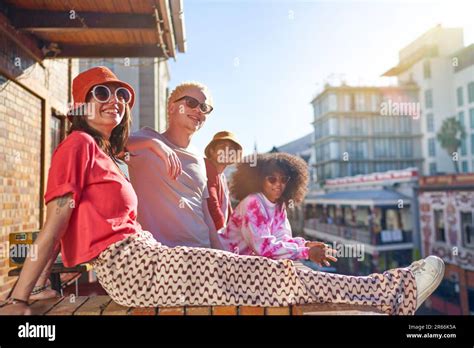 Portrait Happy Cool Young Friends Hanging Out On Sunny City Balcony