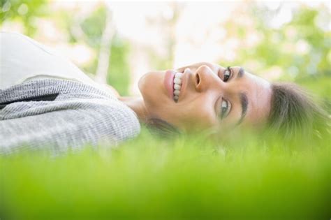Premium Photo Pretty Brunette Lying On The Grass