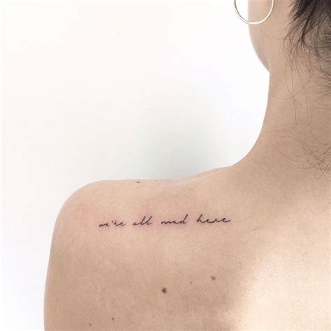 Tatuaje que dice "We're all mad here" (“Todos estamos