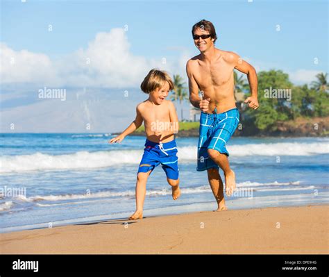 Happy Father And Son Playing And Running Together At Beach Carefree